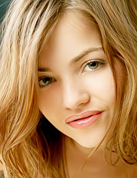 Alice Kiss is rolling around on a bed looking delicious.